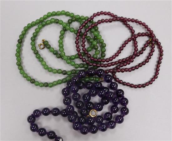 Three gem set bead necklaces, including amethyst and garnet.